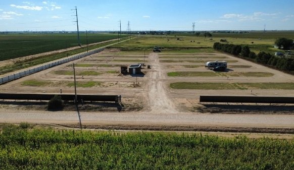 A drone shot looking west over the RV park at sunset.
